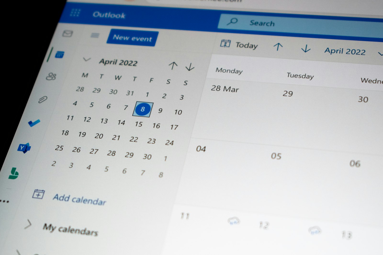 A laptop screen showing a calendar booking interface, the modern solopreneur's scheduling stack