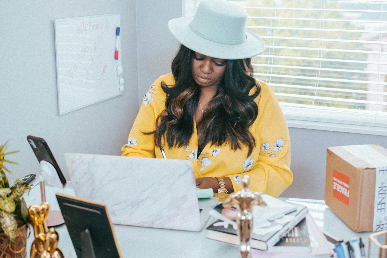 Solopreneur at a small home office desk managing cold email replies on a laptop