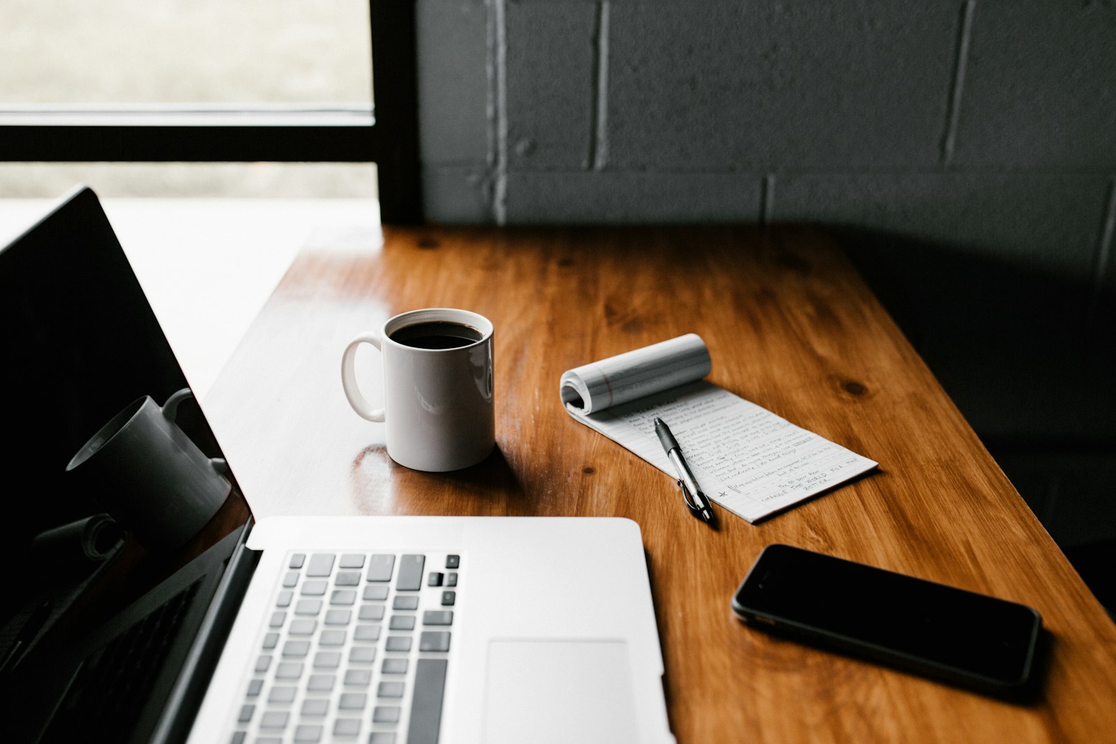 Open source time tracking setup: a self-hosted tracker open on a laptop beside a notebook of billable hours
