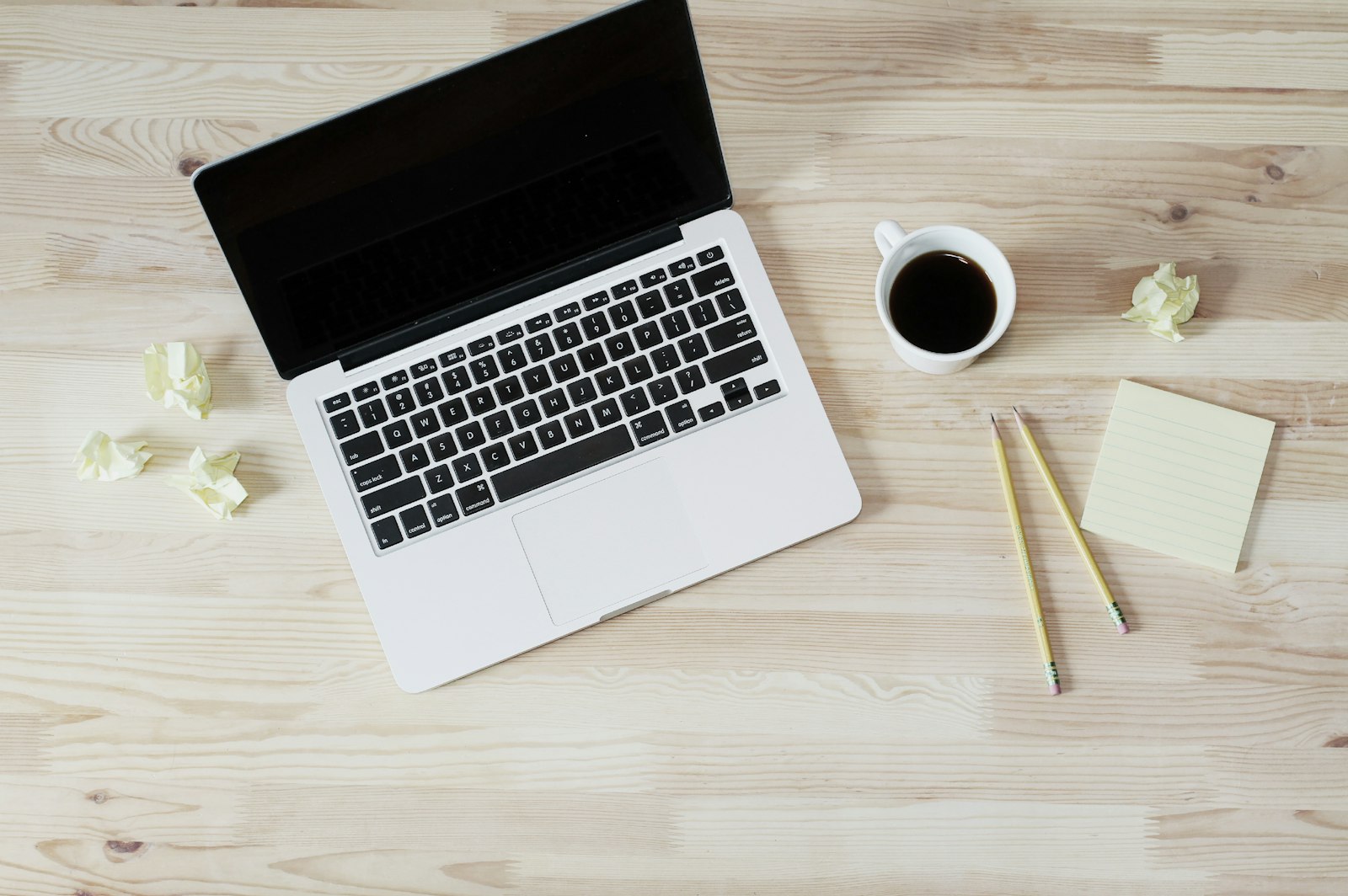 Minimalist freelancer workspace with a simple CRM dashboard open on a laptop